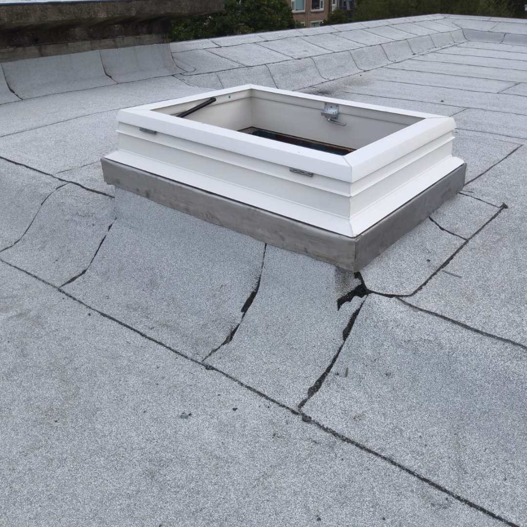 Openklapbaar dakluik geplaatst op bestaande gemetselde opstand voor dagtoegang